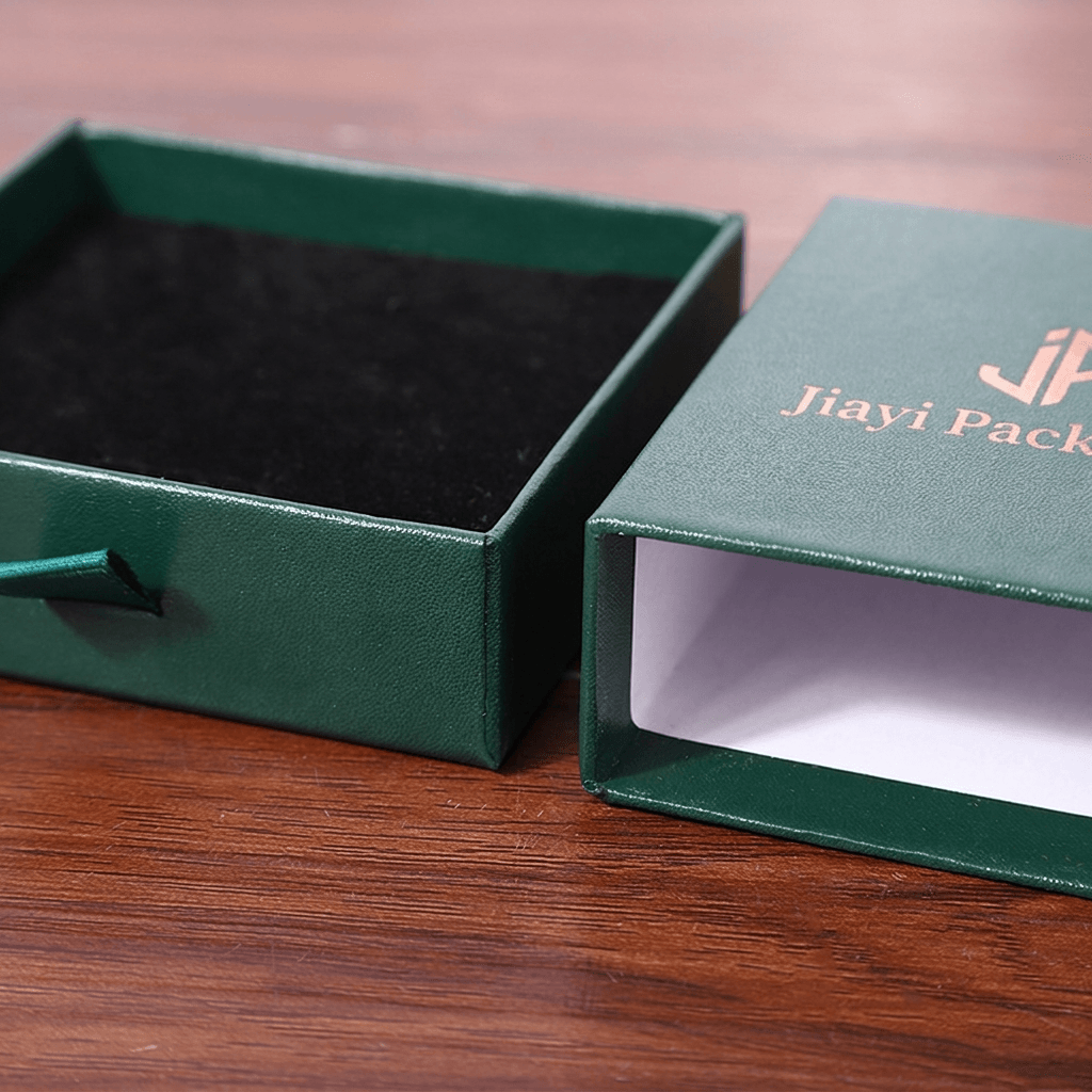 Green jewelry drawer box sleeve beside the sliding tray