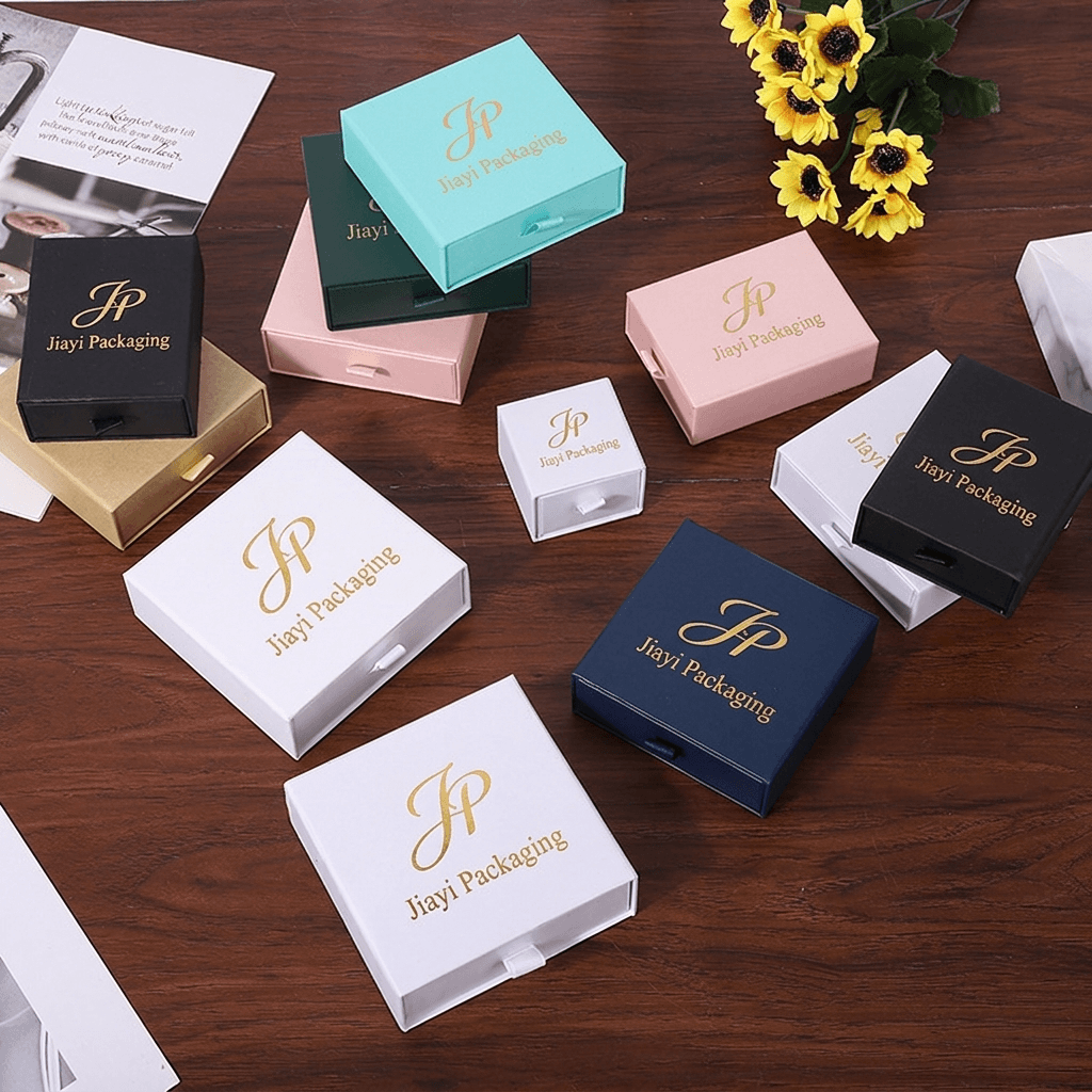 Group of custom jewelry drawer boxes in aqua, green, pink, white, navy, black and gold
